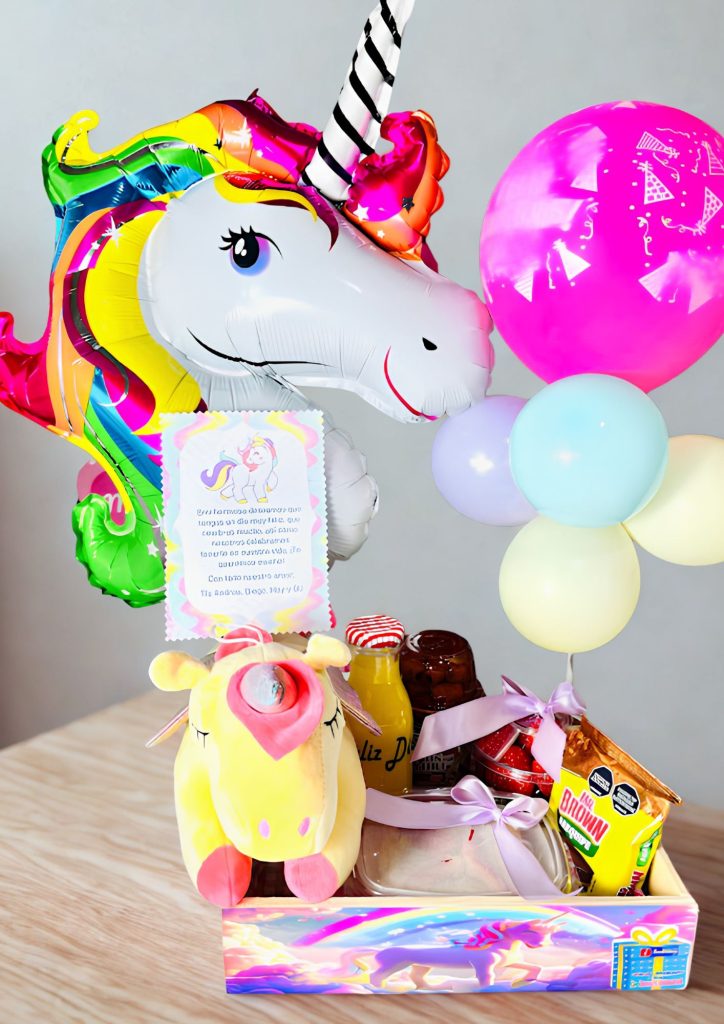 Colorful unicorn foil balloon with rainbow mane beside a pink balloon and pastel balloons at a birthday setup on a wooden floor.